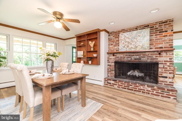 559 Maple Ave, Doylestown, PA 18901 - dining room with a baseboard radiator, wood finished floors, a ceiling fan, ornamental molding, and plenty of natural light