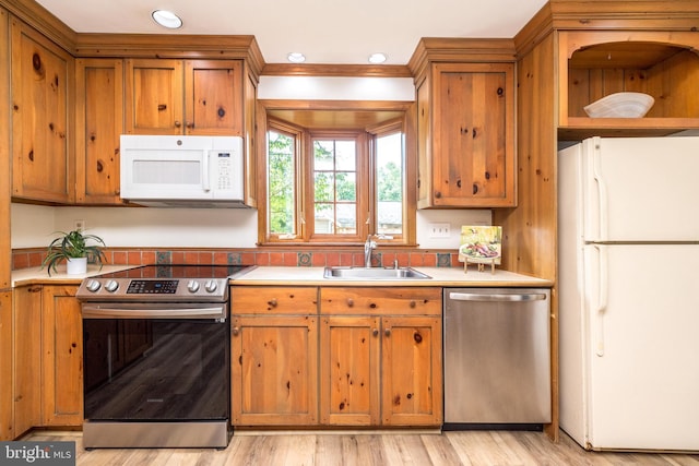 559 Maple Ave, Doylestown, PA 18901 - kitchen with appliances with stainless steel finishes, brown cabinetry, light countertops, light wood-style flooring, and recessed lighting