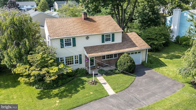 559 Maple Ave, Doylestown, PA 18901 - traditional-style house with concrete driveway, a garage, a chimney, a front lawn, and roof with shingles