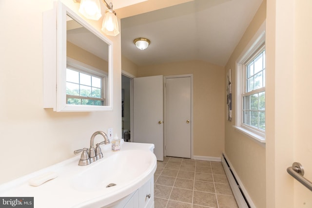 559 Maple Ave, Doylestown, PA 18901 - bathroom with a baseboard heating unit, vanity, vaulted ceiling, and tile patterned floors