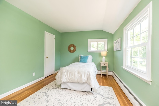 559 Maple Ave, Doylestown, PA 18901 - bedroom featuring wood finished floors, vaulted ceiling, and a baseboard heating unit