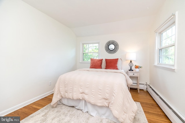 559 Maple Ave, Doylestown, PA 18901 - bedroom featuring a baseboard heating unit, wood finished floors, and lofted ceiling