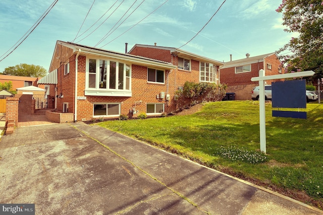 4220 Fort Dupont St SE, Washington, DC 20020 - back of house featuring brick siding and a yard