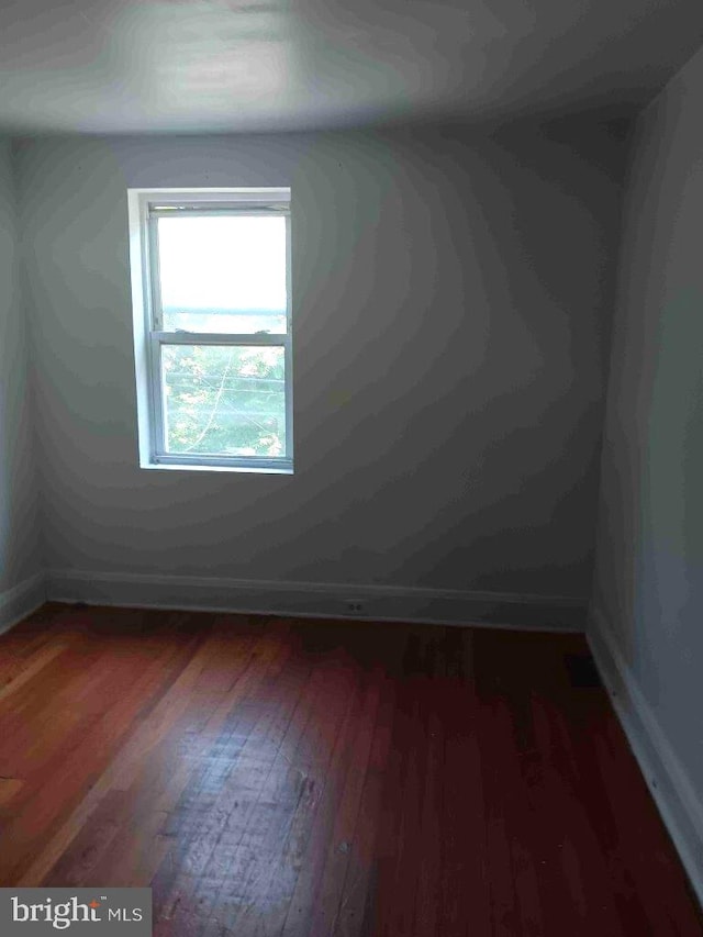 509 N Highland Ave, Baltimore, MD 21205 - spare room featuring wood finished floors and baseboards