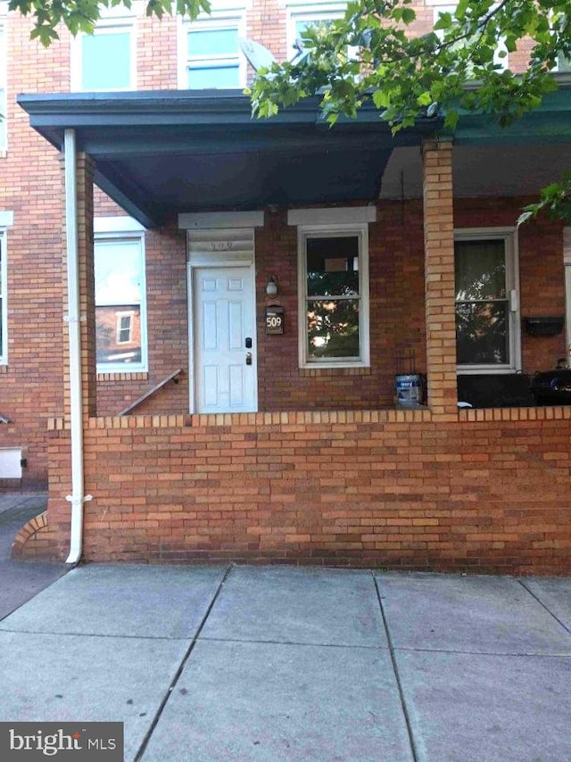 509 N Highland Ave, Baltimore, MD 21205 - entrance to property featuring brick siding and a porch