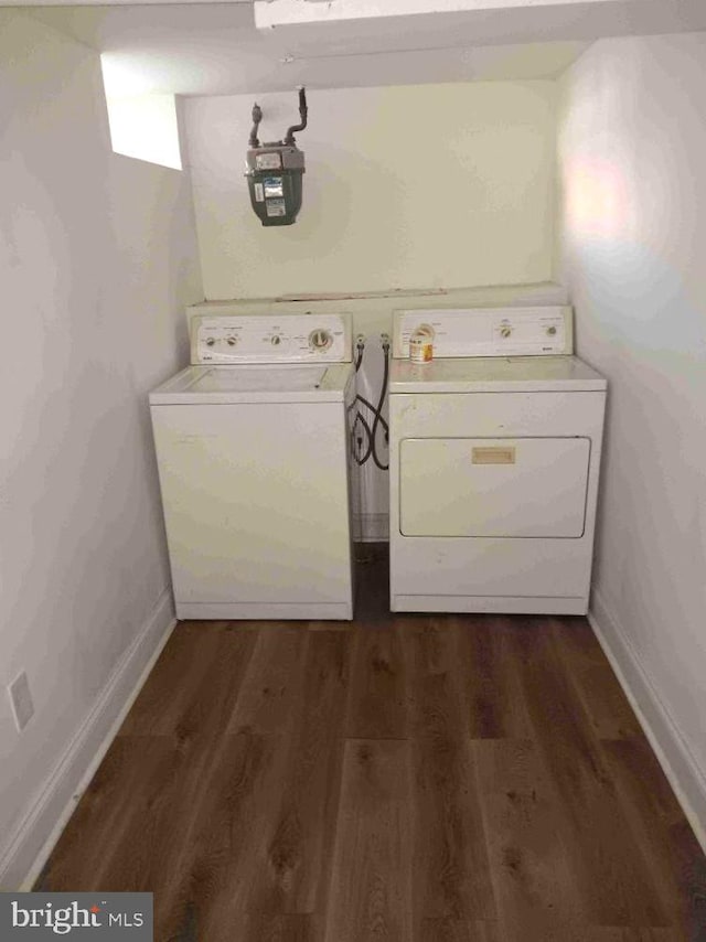 509 N Highland Ave, Baltimore, MD 21205 - washroom featuring washing machine and clothes dryer and dark wood-style flooring