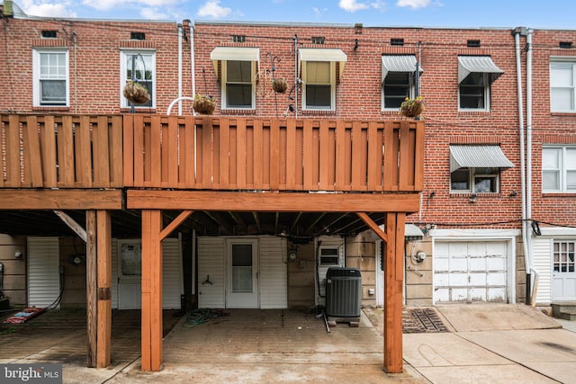 4130 Merrick St, Philadelphia, PA 19128 - rear view of property with concrete driveway, an attached garage, and brick siding
