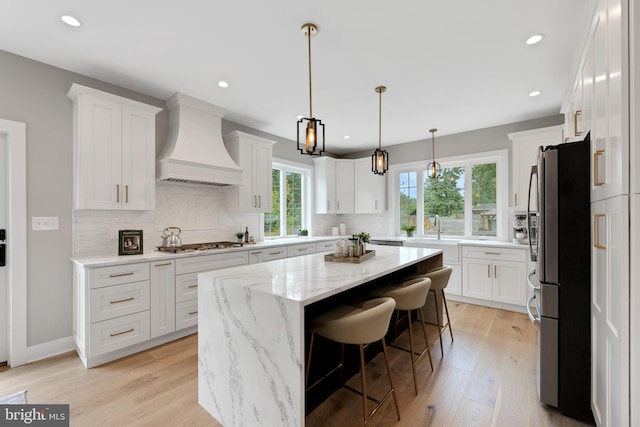 45 Orchard Ln, Berwyn, PA 19312 - kitchen featuring premium range hood, appliances with stainless steel finishes, a center island, white cabinetry, and recessed lighting