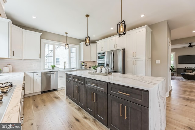 45 Orchard Ln, Berwyn, PA 19312 - kitchen featuring stainless steel appliances, white cabinetry, light wood-style floors, tasteful backsplash, and recessed lighting