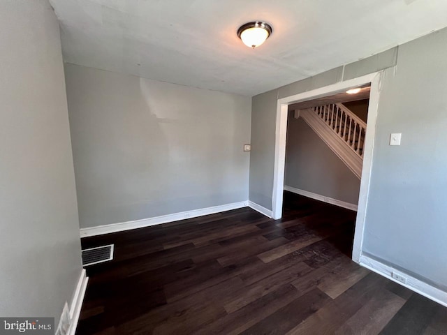 305 Delamore Pl, Wilmington, DE 19805 - unfurnished room featuring dark wood-type flooring and stairway