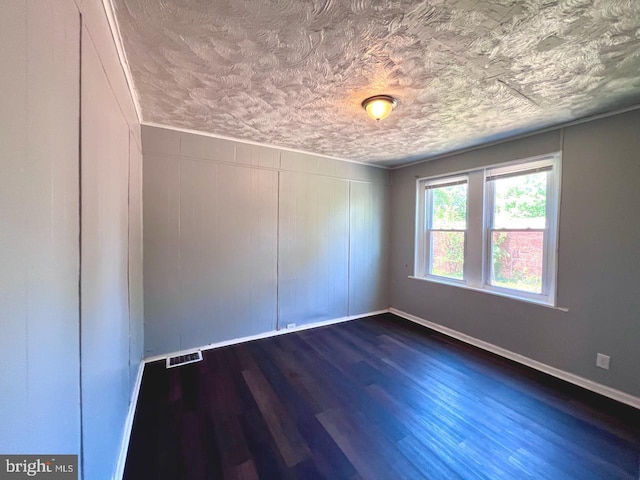 305 Delamore Pl, Wilmington, DE 19805 - unfurnished room featuring a textured ceiling and dark wood-style flooring