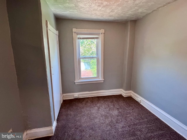 305 Delamore Pl, Wilmington, DE 19805 - unfurnished bedroom featuring dark colored carpet and a textured ceiling