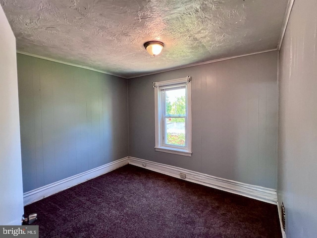 305 Delamore Pl, Wilmington, DE 19805 - spare room with dark colored carpet, crown molding, and a textured ceiling