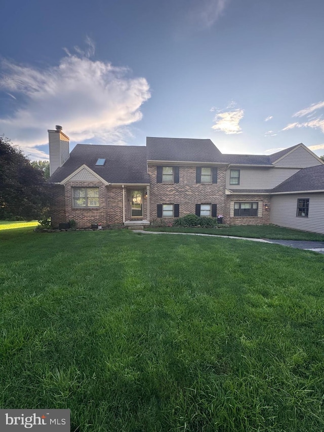 1872 Yingling Dr, Spring Grove, PA 17362 - view of front of house with brick siding, a chimney, and a front yard