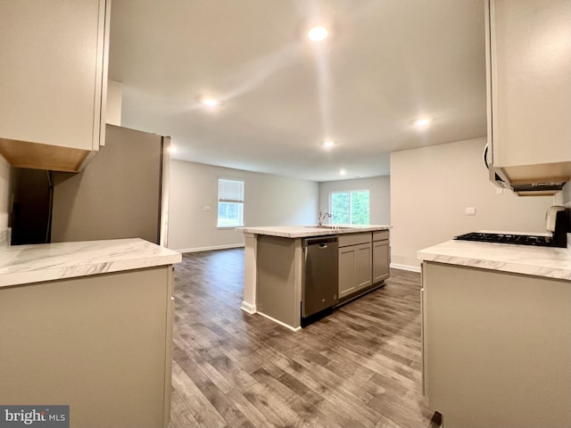 22189 Shorebird Way, Millsboro, DE 19966 - kitchen featuring stainless steel dishwasher, dark wood finished floors, recessed lighting, light countertops, and a kitchen island with sink