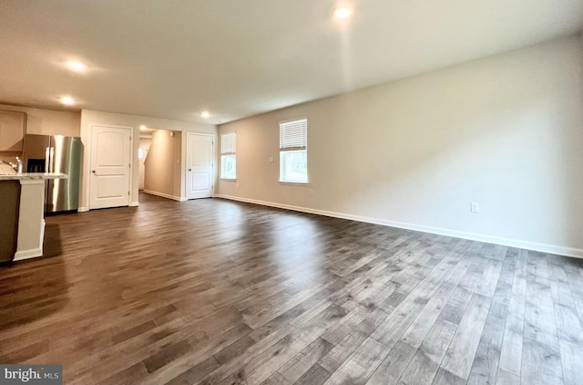 22189 Shorebird Way, Millsboro, DE 19966 - unfurnished living room featuring dark wood finished floors and recessed lighting