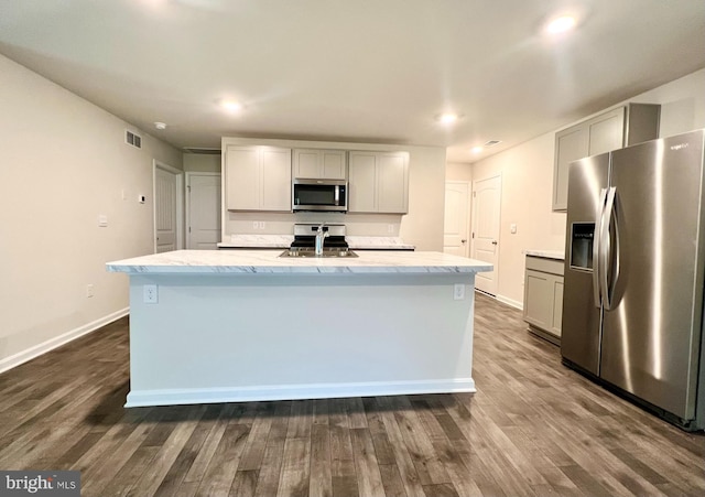 22189 Shorebird Way, Millsboro, DE 19966 - kitchen featuring appliances with stainless steel finishes, dark wood finished floors, gray cabinets, a kitchen island with sink, and recessed lighting
