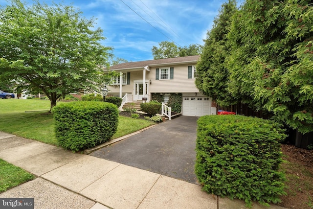 709 Parmentier Rd, Warminster, PA 18974 - bi-level home with driveway, a garage, and a front yard