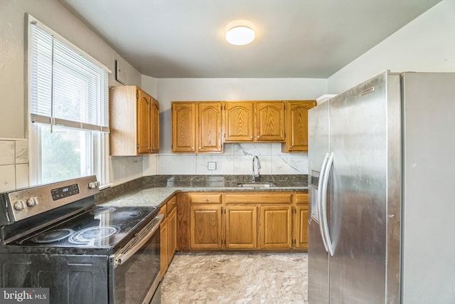 1505 E Barringer St, Philadelphia, PA 19150 - kitchen featuring stainless steel appliances, brown cabinetry, tasteful backsplash, and dark stone counters