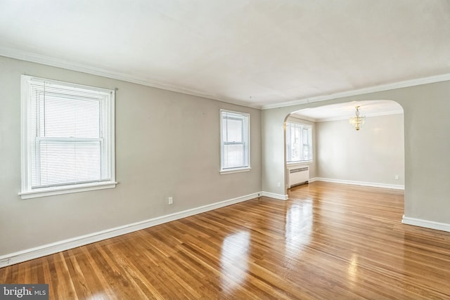 1505 E Barringer St, Philadelphia, PA 19150 - unfurnished room with arched walkways, crown molding, wood finished floors, radiator, and a chandelier