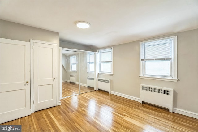 1505 E Barringer St, Philadelphia, PA 19150 - unfurnished bedroom featuring radiator heating unit, light wood-type flooring, and a closet