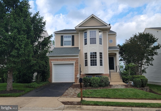 14387 Newbern Loop, Gainesville, VA 20155 - view of front of house featuring an attached garage, driveway, brick siding, and roof with shingles