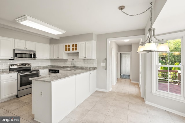13619 Flintwood Pl, Herndon, VA 20171 - kitchen with stainless steel appliances, tasteful backsplash, white cabinetry, light stone counters, and a peninsula