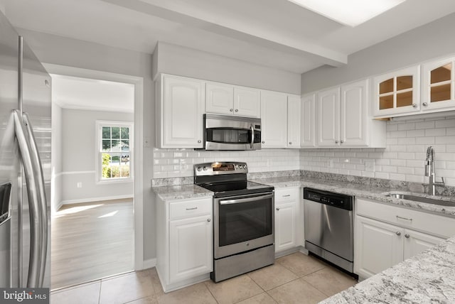 13619 Flintwood Pl, Herndon, VA 20171 - kitchen featuring stainless steel appliances, tasteful backsplash, white cabinets, and light tile patterned flooring