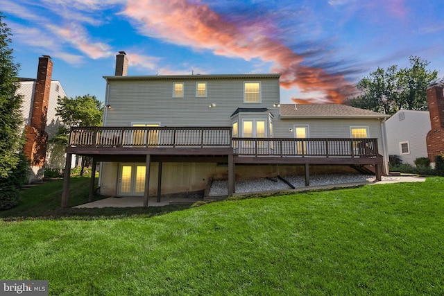 13619 Flintwood Pl, Herndon, VA 20171 - back of property at dusk featuring french doors, a wooden deck, a yard, a chimney, and a patio