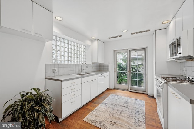 2205 Pine St, Philadelphia, PA 19103 - kitchen featuring white appliances, recessed lighting, tasteful backsplash, white cabinetry, and light countertops
