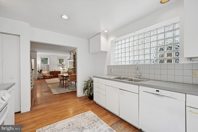 2205 Pine St, Philadelphia, PA 19103 - kitchen with white dishwasher, decorative backsplash, recessed lighting, light wood-type flooring, and white cabinets