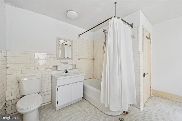 2205 Pine St, Philadelphia, PA 19103 - full bath featuring vanity, tile walls, shower / bath combo with shower curtain, tile patterned floors, and a wainscoted wall