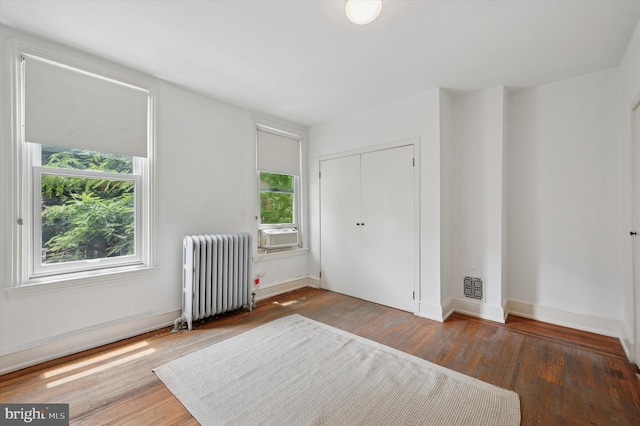 2205 Pine St, Philadelphia, PA 19103 - unfurnished bedroom with radiator, wood finished floors, a closet, and cooling unit
