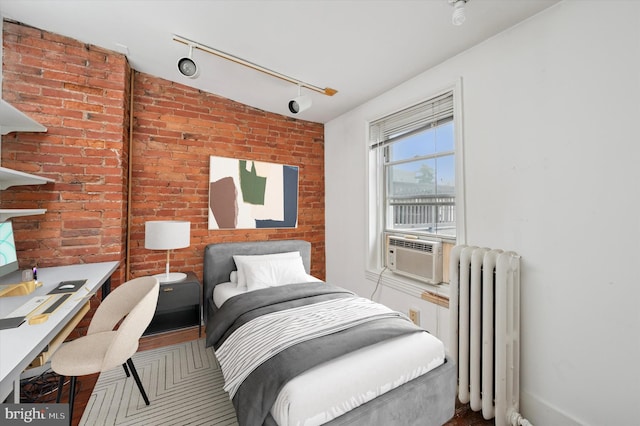 2205 Pine St, Philadelphia, PA 19103 - bedroom featuring radiator heating unit, cooling unit, brick wall, and rail lighting