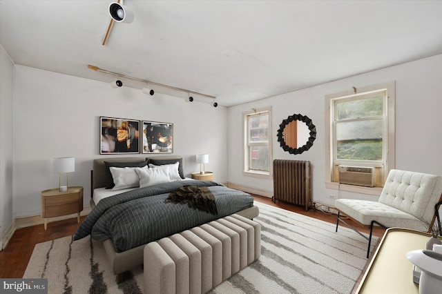 2205 Pine St, Philadelphia, PA 19103 - bedroom featuring radiator, wood finished floors, rail lighting, and cooling unit