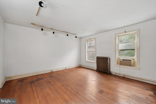 2205 Pine St, Philadelphia, PA 19103 - unfurnished room with radiator heating unit, cooling unit, wood finished floors, and track lighting