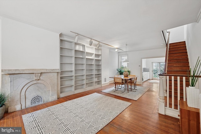2205 Pine St, Philadelphia, PA 19103 - living room featuring wood finished floors, stairs, built in shelves, and a fireplace