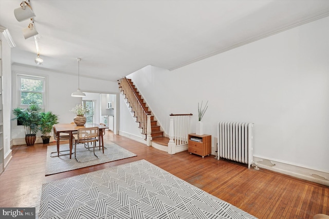 2205 Pine St, Philadelphia, PA 19103 - dining space featuring radiator, wood finished floors, stairs, and crown molding