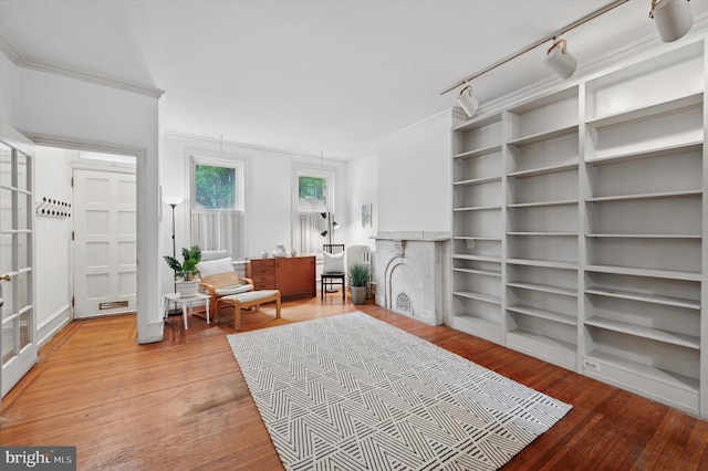 2205 Pine St, Philadelphia, PA 19103 - sitting room featuring light wood-style flooring, rail lighting, a fireplace, and ornamental molding