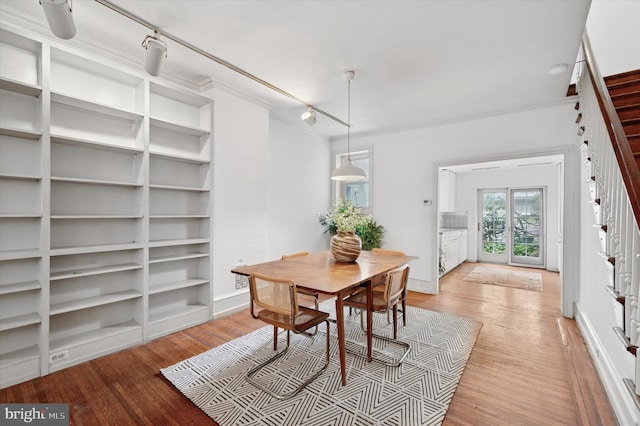2205 Pine St, Philadelphia, PA 19103 - dining room featuring track lighting, light wood-style floors, built in shelves, and ornamental molding