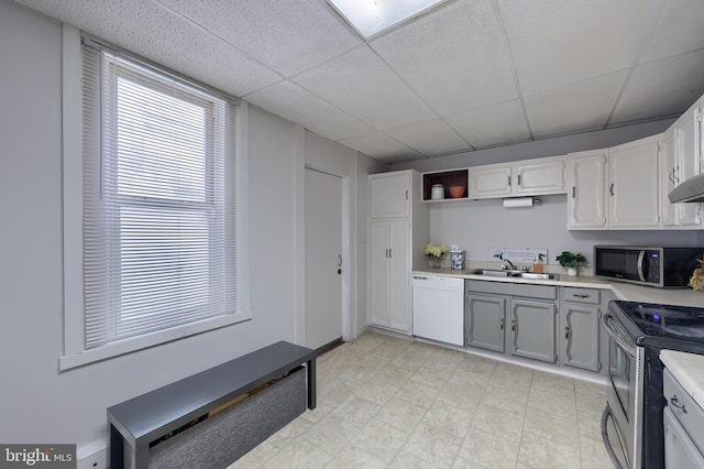 68 Locust St, Lancaster, PA 17602 - kitchen with stainless steel appliances, light countertops, a paneled ceiling, open shelves, and gray cabinetry