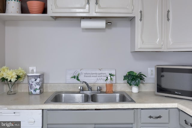 68 Locust St, Lancaster, PA 17602 - kitchen featuring white dishwasher, stainless steel microwave, light countertops, and white cabinets