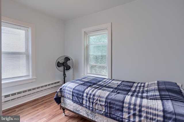 68 Locust St, Lancaster, PA 17602 - bedroom featuring a baseboard heating unit and wood finished floors