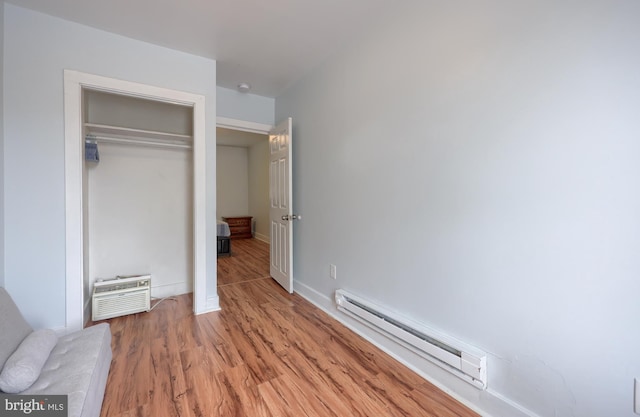68 Locust St, Lancaster, PA 17602 - unfurnished bedroom featuring a baseboard heating unit, light wood-type flooring, and a closet