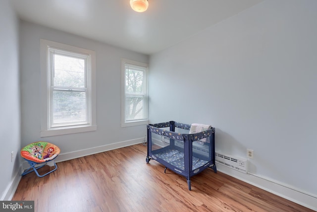 68 Locust St, Lancaster, PA 17602 - bedroom featuring wood finished floors and a baseboard radiator