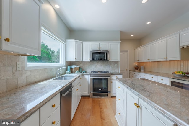 12 Dalton Way, Holland, PA 18966 - kitchen featuring stainless steel appliances, white cabinets, recessed lighting, light wood finished floors, and backsplash