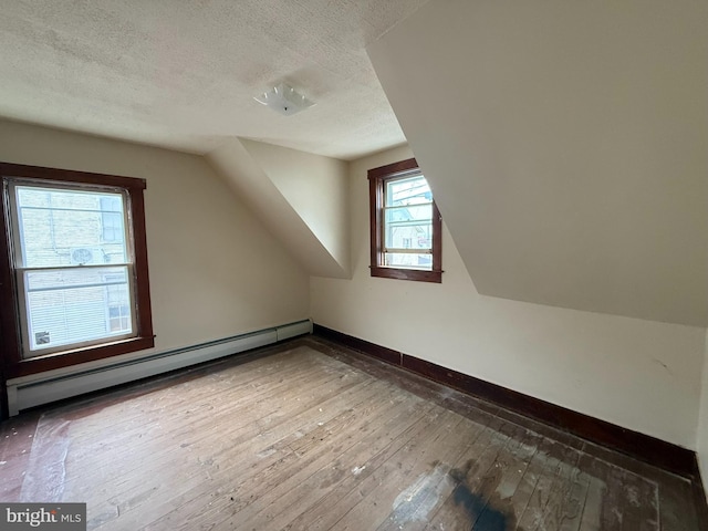 77 Spring St, Beaver Springs, PA 17812 - bonus room featuring a baseboard heating unit, hardwood / wood-style floors, a textured ceiling, and vaulted ceiling