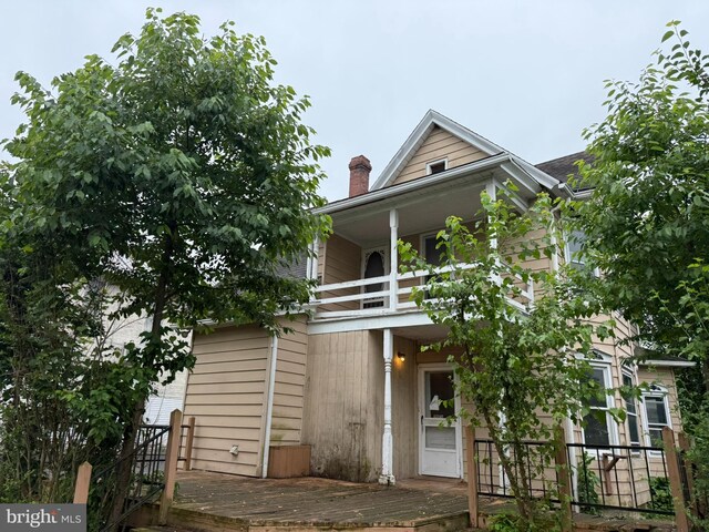 77 Spring St, Beaver Springs, PA 17812 - view of front of house featuring a balcony and a chimney