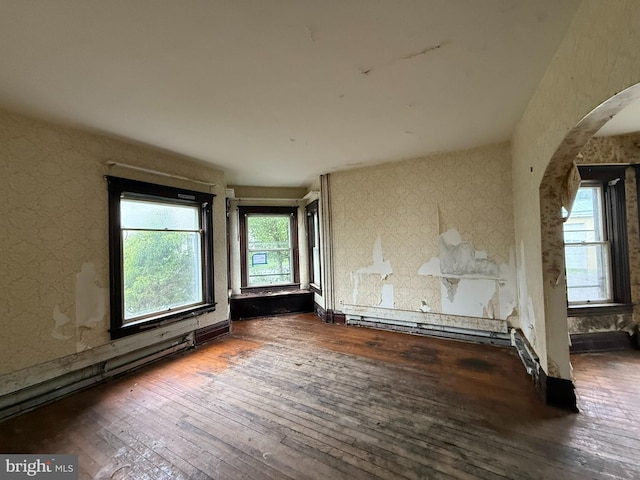77 Spring St, Beaver Springs, PA 17812 - empty room featuring arched walkways, hardwood / wood-style flooring, and wallpapered walls