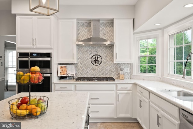 10207 Daylily Ct, Manassas, VA 20110 - kitchen with wall chimney range hood, stainless steel appliances, white cabinetry, and backsplash